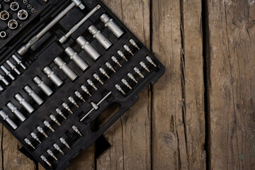 Tool kit on the wood background. Wrenches and bits.