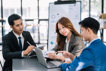 Businessman working as a team start meeting the new marketing project plan By business people using tablets and graph documents Calculate the amount of money for the project.