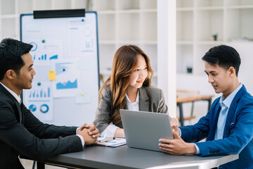 Businessman working as a team start meeting the new marketing project plan By business people using tablets and graph documents Calculate the amount of money for the project.