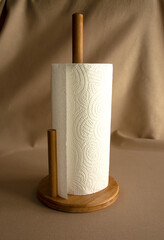 Rolled paper towels in a wooden towel holder.