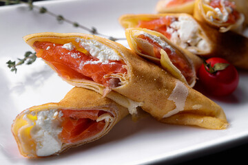 fried pancakes with salmon and cream cheese, close-up