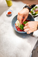 Close up of chef's hands cooking asian pho bo soup on restaurant kitchen