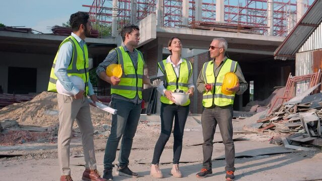Group team engineer or contractor holding hardhat relax and talking with happy at construction site, architect and worker discussion while break and leisure together, teamwork and industrial concept.