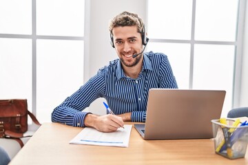 Young man call center agent smiling confident working at office