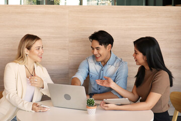 Full concentration at work. Multi-ethnic business people sitting and discussing in the office, best collaboration concept for work