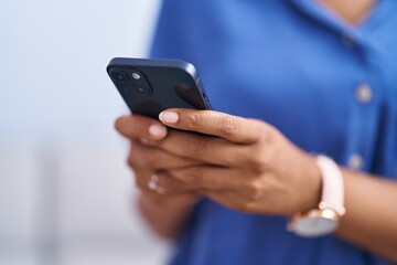 African american woman using smartphone at home