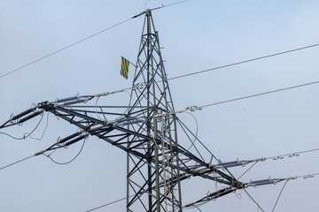 power lines on a sky with danger flagg