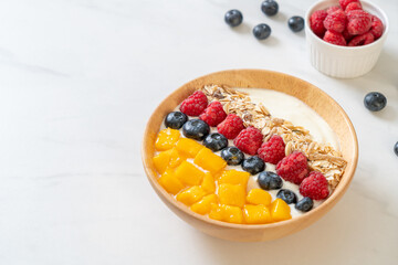 homemade yogurt bowl with raspberry, blueberry, mango and granola