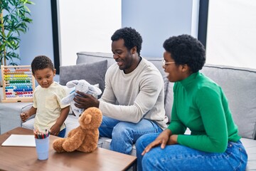 African american family playing with teddy bear at home