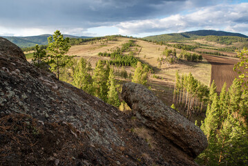 Rocks with pine trees against the sky, spring
