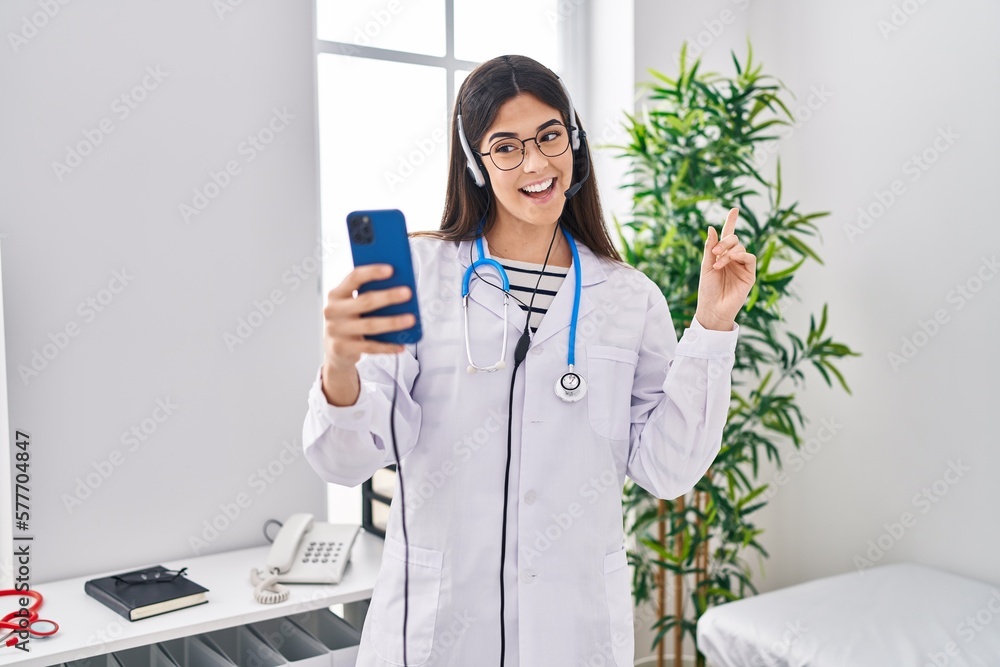 Poster Young brunette woman working on online appointment smiling happy pointing with hand and finger to the side