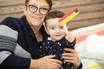 Cute Little Grandson With Old Grandmother Having Fun. Senior Woman Playing With Grandchild. Family Happy Moments, Family Values , Multi-Generation Tender Moments.
