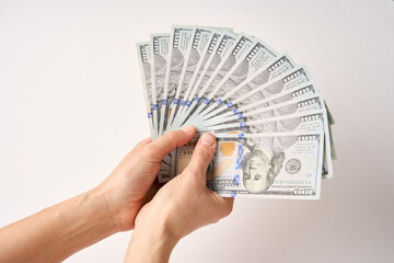 Hands holding Dollar money bills, white background, close-up
