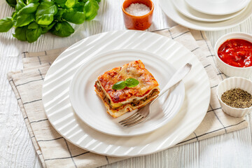 portion of Lasagna on white plate, top view