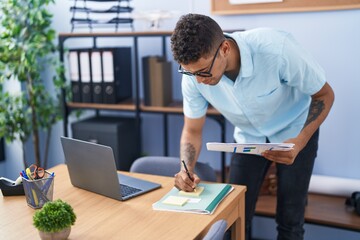 African american man business worker writing on document working at office