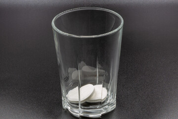 Dissolving instant effervescent tablets in a glass closeup