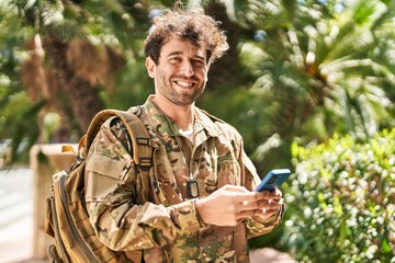 Young man army soldier using smartphone at park