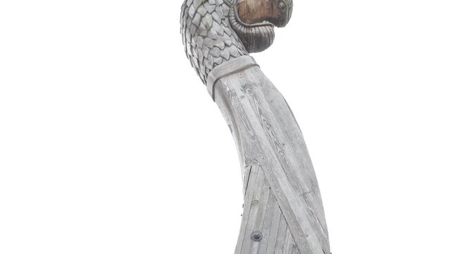 Prow of a Viking ship. Drakkar. Wooden figurine of a dragon on the bow of the ship