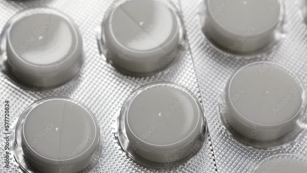 Poster white pills in a blister are rotated in a circle