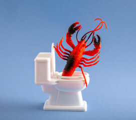 A huge lobster climbs out of the toilet. Humor concept of toilet blockage.