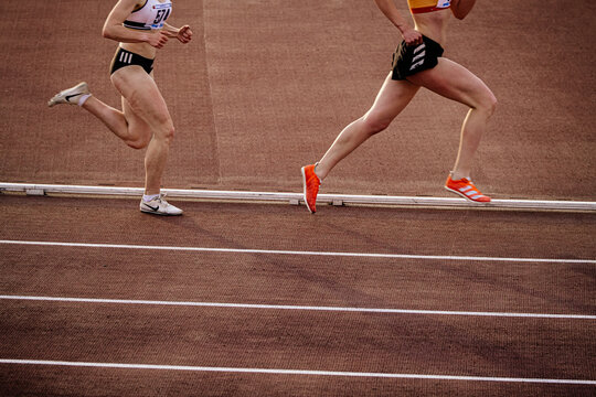 Chelyabinsk, Russia - June 4, 2022: female runners in spikes shoes Adidas and Nike running middle distance at stadium during UFD Athletics Championship