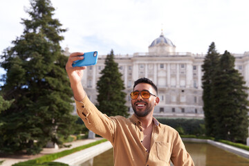 latino man taking a selfie as a tourist in Madrid