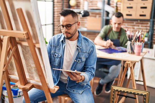 Two men artists drawing at art studio