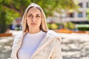 Young woman with relaxed expression standing at park