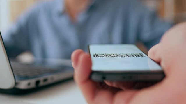 E-commerce, Woman business man Confident scans a barcode on a phone in an office room packaging department Close-up The packer of goods is in an industrial workshop robotic and autonomous, parcel box
