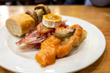 Board with typical snacks of Basque Country, pinchos or pinxtos, skewers or small piece of bread with toppings, served in bar in San-Sebastian or Bilbao, Spain
