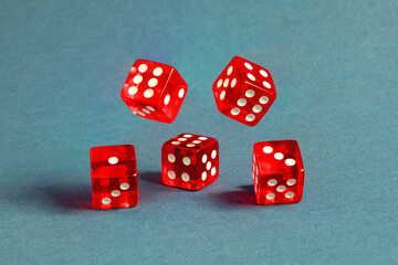 Random number generator. Five red dice with numerical values lie in a chaotic order.