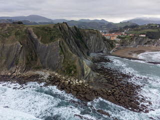 View on steeply-tilted layers of flysch geological formation on Atlantic coast at Zumaia, Basque Country, Spain