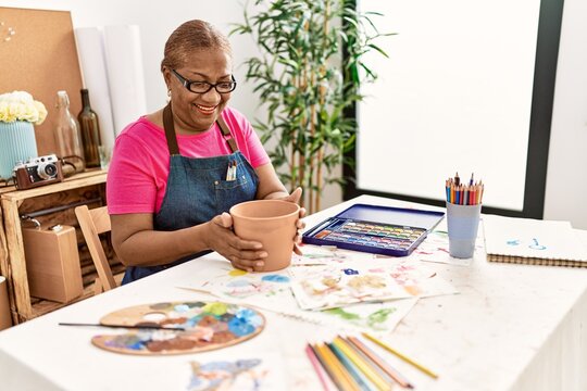 Senior african american woman smiling confident making clay ceramic at art studio