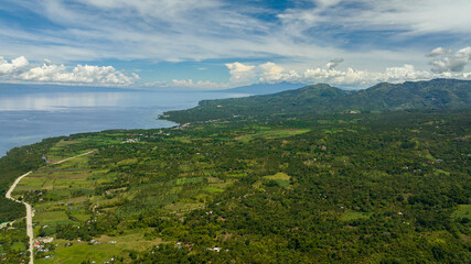 Aerial drone of coastline of Negros Island with towns and villages. Philippines.