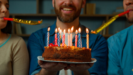 Cropped view caucasian adult happy bearded man celebrate birthday at home diverse african caucasian...