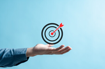 Business hands holding target icon, dartboard and arrow for creative and set up business objective...