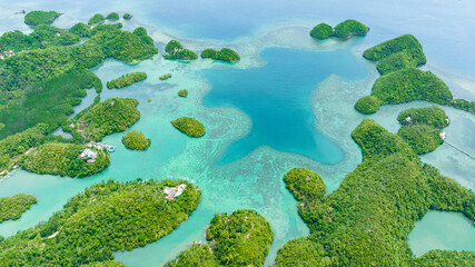 Aerial drone of islands in the turquoise water of the lagoon. Seascape in the tropics. Sipalay, Negros, Philippines.