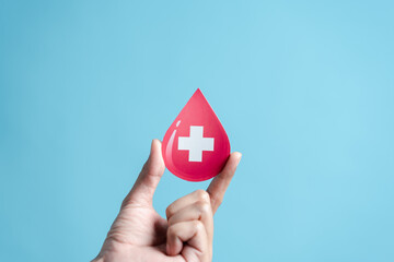 hands holding blood drop paper cut, blood transfusion, world blood donor day, red cross to give...