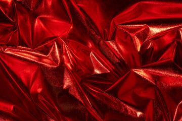 Abstract red crumpled foil background. Minimal Christmas, love or party concept.