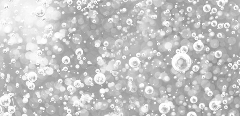 Bubbles underwater in bright light. Background of oxygen bubbles in black and white tones with bokeh