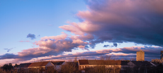 Dramatic cloudscape over the barren trees and houses after winter rain storm in Gaithersburg, Maryland