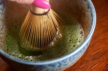 Preparation of green Matcha tea from finely ground powder of specially grown and processed green tea leaves consumed in East Asia.