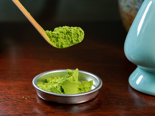 Preparation of green Matcha tea from finely ground powder of specially grown and processed green tea leaves consumed in East Asia.