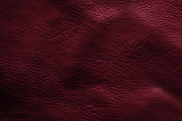 Crumpled texture of dark red cowhide, close up. Leather background.	