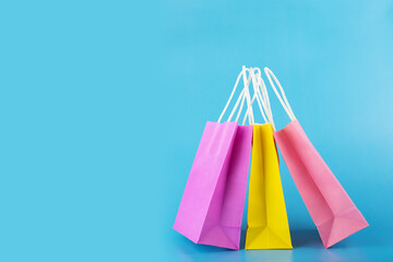 shopping bags on blue background, purchase shopper, sale and discount, copy space