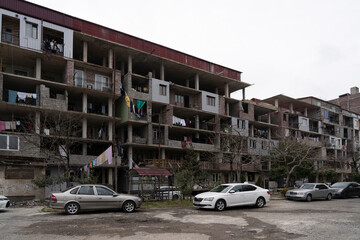 Fototapeta premium Batumi, Georgia - March 3, 2023: unfinished apartment building in which people live