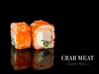 Close up to sushi roll pieces with mirror reflection on black background. roll with crab meat, cream cheese, cucumber and flying fish roe on top. Ready menu advertising banner with text and copy space