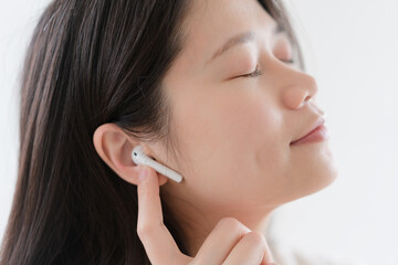 woman listen music in wireless earphones