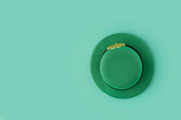 saint patrick day, green irish leprechaun hat with gold clover, top view, copy space