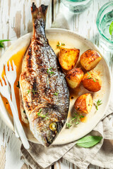 Sea Bream roasted with potatoes, cherry tomatoes and thyme